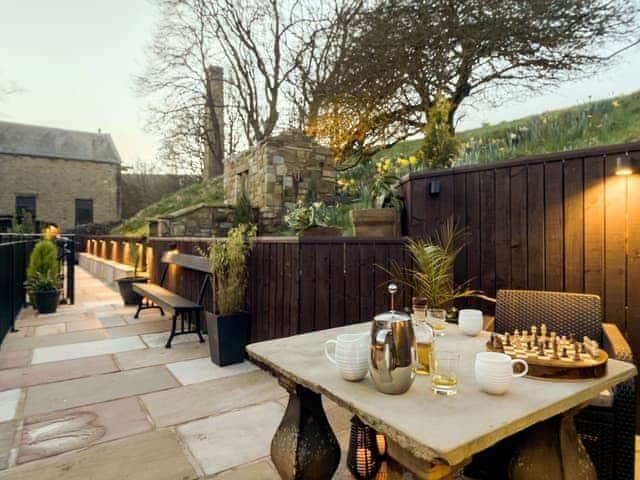 Terraced patio illuminated during the evening | Narrowgates Cottage, Barley, near Barrowford