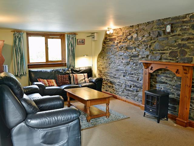 Charmingly furnished living room with electric wood burner | Coriander - Sherrill Farm Holiday Cottages, Dunterton, near Tavistock