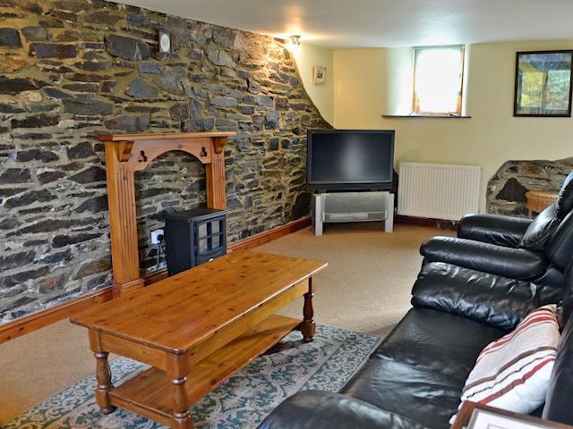 Charmingly furnished living room with electric wood burner | Coriander - Sherrill Farm Holiday Cottages, Dunterton, near Tavistock