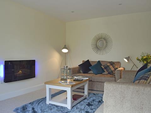 Tastefully decorated open plan living space, living area complete with electric fire and 43 inch Smart TV | Duran Holiday Cottages - Casa Duran - Duran Holiday Cottages , Killin