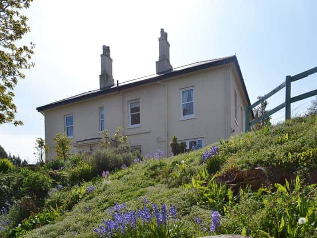 Situated amongst extensive and well-kept gardens