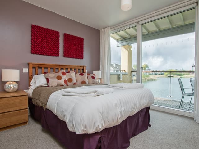 Double bedroom with patio doors leading to balcony | The Augusta House, Somerford Keynes