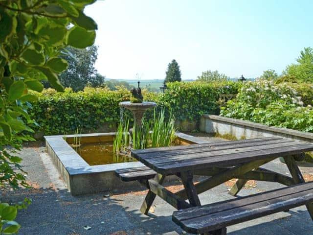 Unfenced pond and garden furniture | Stable End - Peregrine Hall Cottages, Lostwithiel