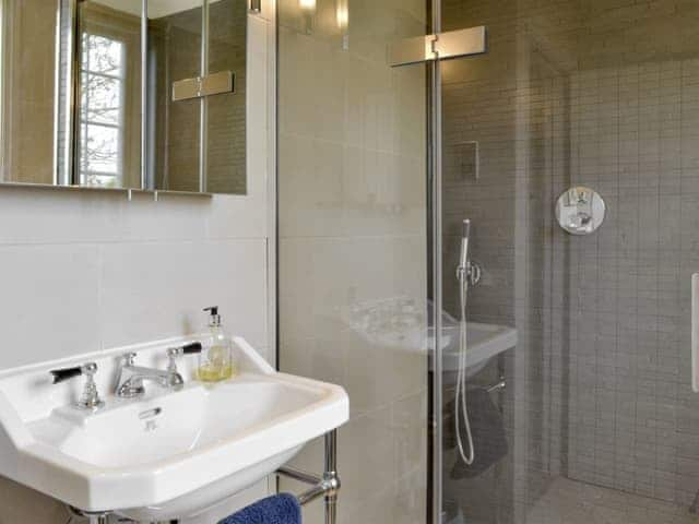 Family bathroom with luxury shower cubicle and separate bath | Holly Cottage, Pett