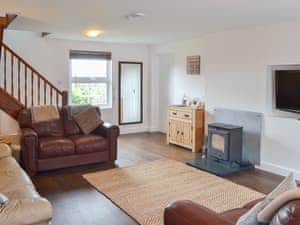 Delightful living room with electric wood burner effect heater  | Rhos Y Grug, Llangwnadl, near Pwllheli
