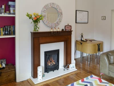 Cosy living and dining room with flame effect gas fire | Naters Apartment, Whitley Bay, near Cullercoats