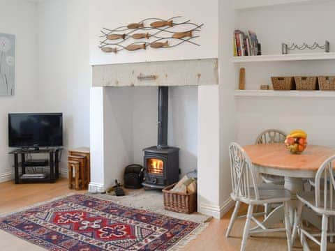 Spacious living/ dining room with wood burner | Dipper Cottage, Seahouses