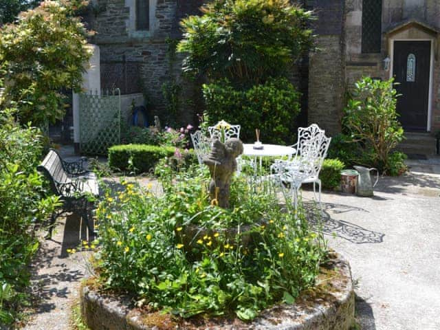 Courtyard with seating area | Stable Cottage - Peregrine Hall Cottages, Lostwithiel