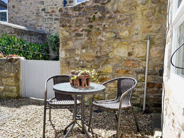 Pebbled patio with garden furniture to the front of the house | Dove Cottage, Barnard Castle