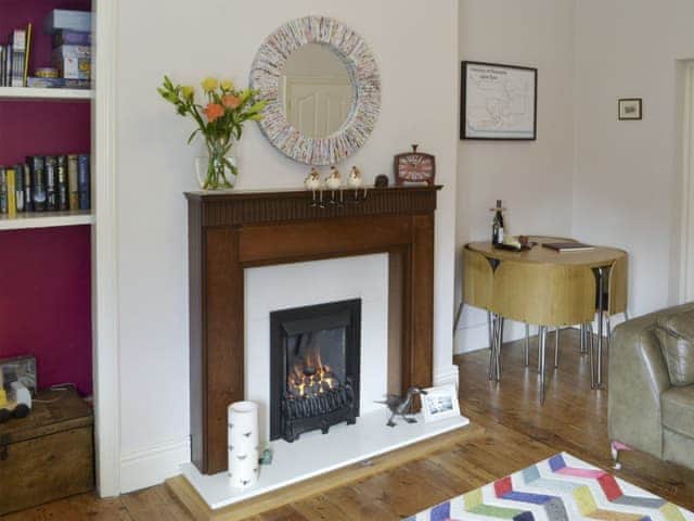 Cosy living and dining room with flame effect gas fire | Naters Apartment, Whitley Bay, near Cullercoats