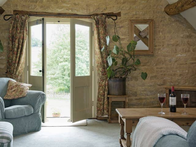 Lving room french doors leading to the garden | Flowers Barn, Middle Duntisbourne, near Cirencester