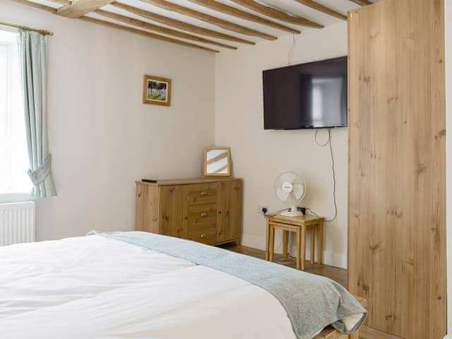 Dressing area and wall mounted TV within double bedroom | The Plough, Bampton, near Witney