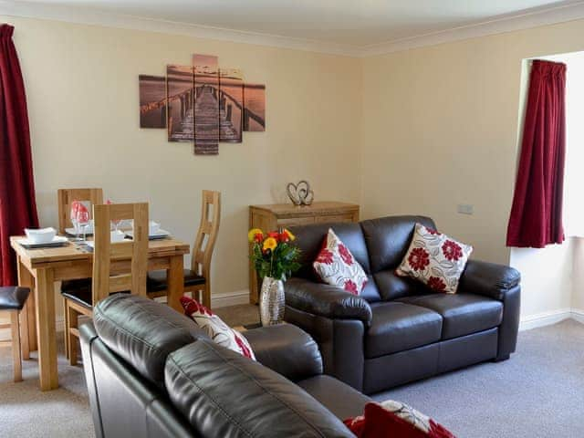 Attractive living and dining room with feature fireplace | 2 Lonsdale House - Greta Grove Apartments, Keswick