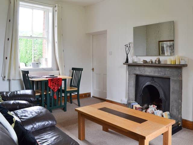 Delightful living/dining room with feature fireplace | Ticket Office - Torver Station Cottages, Torver, near Coniston