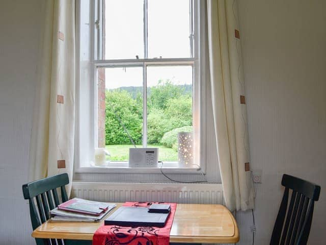 Compact dining area with wonderful view over the garden to the fells beyond | Ticket Office - Torver Station Cottages, Torver, near Coniston