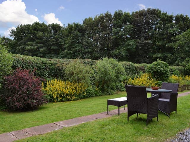 Leafy garden with lovely sitting out area | Ticket Office - Torver Station Cottages, Torver, near Coniston