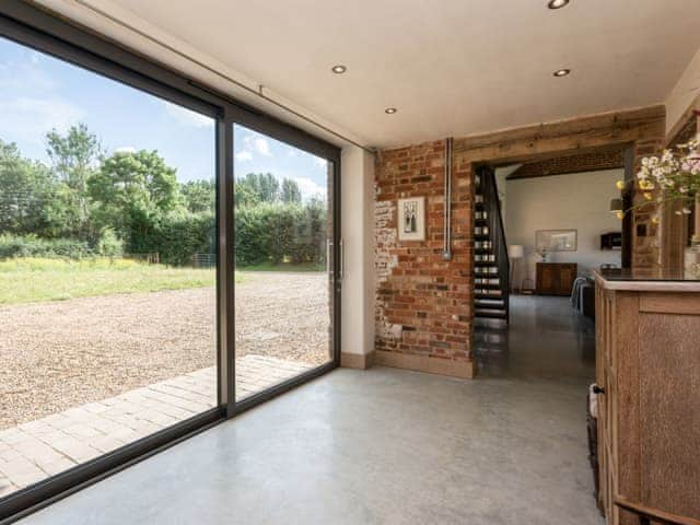 Hallway with large sliding door | Old Hall Farm Barn, Kerdiston, near Norwich