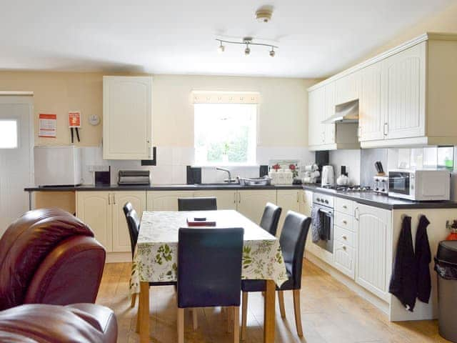 Convenient dining area and well-equipped kitchen | Primrose - Clapham Holme Farm Cottages, Great Hatfield, near Hornsea