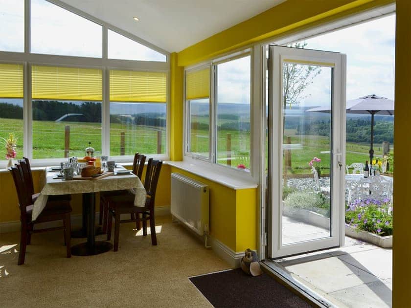 The picture windows in the sun room enhance the views  | Squirrel Cottage - Holystone Estate, Farnham, near Rothbury