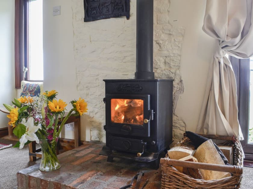 Warm and welcoming wood burner in the living area | Grooms Cottage - Arkleby Holiday Homes, Arkleby, near Cockermouth