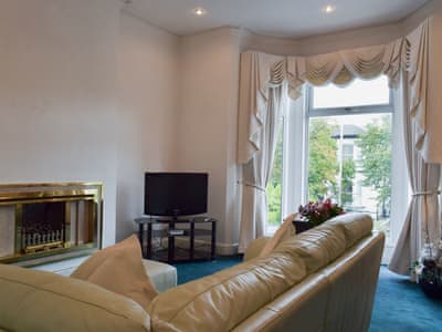 Spacious living room with beautiful bay window | Ash Villas, Southport