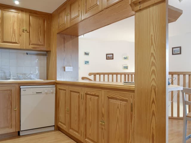 Fitted kitchen with serving hatch to dining area | Leyfield Coach House, Kirkby Lonsdale