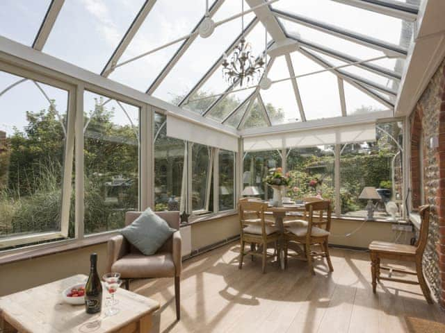 Light and airy conservatory overlooking the garden | Dell Cottage, Mundesley, near North Walsham