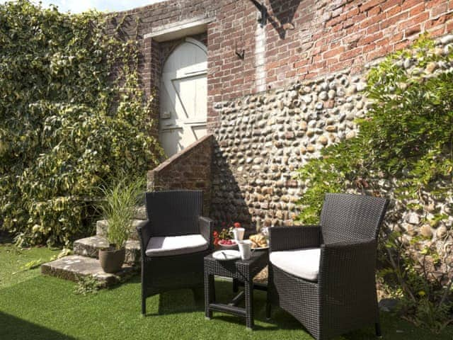 Pretty sitting area with garden furniture | Dell Cottage, Mundesley, near North Walsham