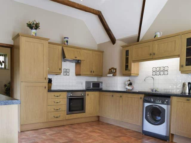 Large kitchen/dining room with terracotta tiled floor and French doors | Alfie&rsquo;s Barn, Ambrosden