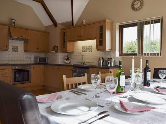 Large kitchen/dining room with terracotta tiled floor and French doors | Alfie&rsquo;s Barn, Ambrosden