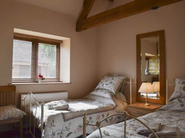 Twin bedroom with exposed stone walls | Alfie&rsquo;s Barn, Ambrosden