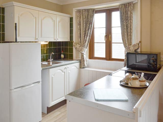 Well-equipped fitted kitchen | Hayloft - Penmorvah Manor Courtyard Cottages, Budock Water, near Falmouth