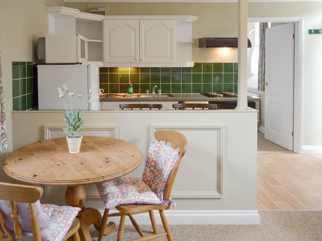 Convenient dining area | Horseshoe - Penmorvah Manor Courtyard Cottages, Budock Water, near Falmouth