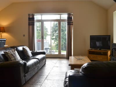 Comfortable lounge with wood burner and Freeview TV | Durham Cottage - Bowlees Holiday Cottages, Wolsingham, near Stanhope
