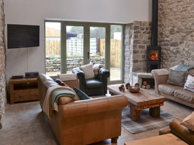 Living room with wood burner and French doors leading to garden | The Barn, Harwood Dale, near Scarborough