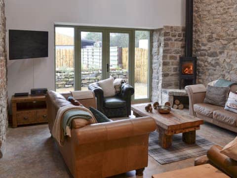 Living room with wood burner & French doors leading to garden | The Barn, Harwood Dale, near Scarborough