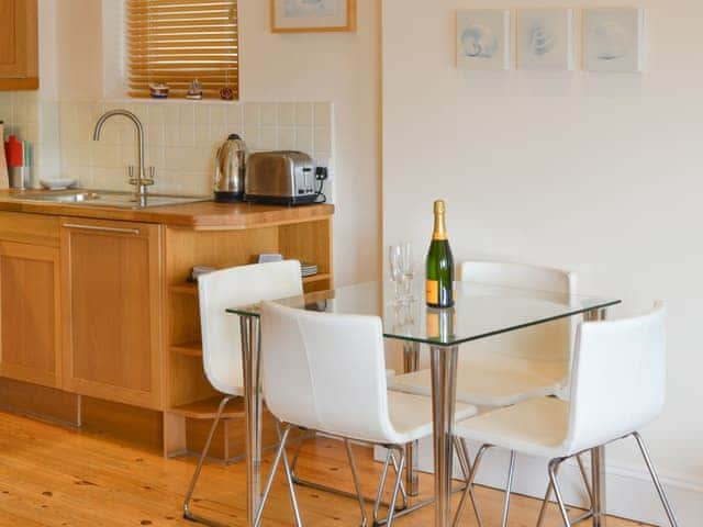 Living area with contemporary dining table and chairs | Tides Reach, Fowey