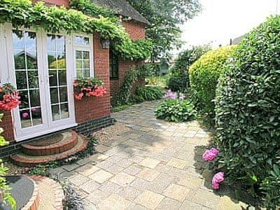 Patio and French doors | Starboard Cottage, Winterton-on-Sea, near Great Yarmouth