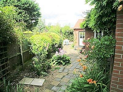 Garden areas around the patio | Starboard Cottage, Winterton-on-Sea, near Great Yarmouth