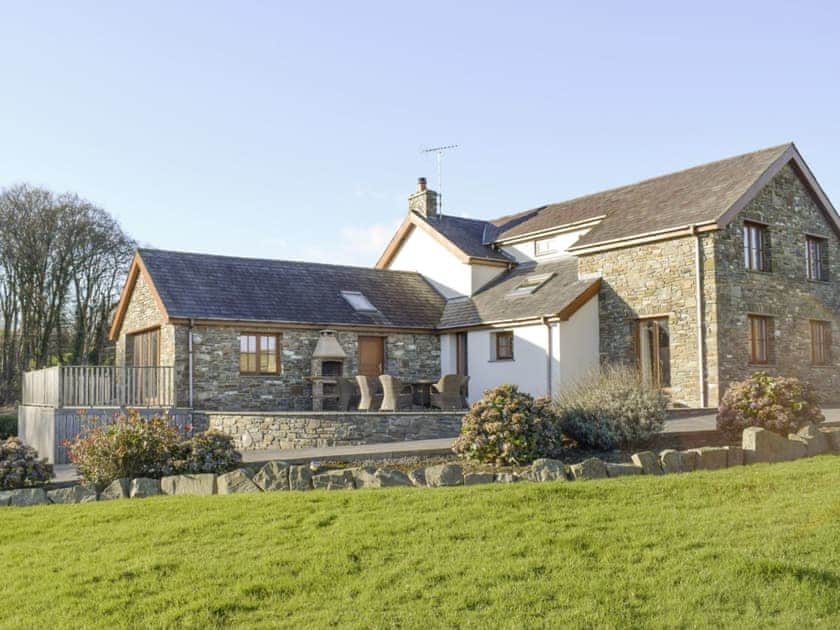Rear of property with raised patio area | The Farmhouse - Ffynnonmeredydd Cottages, Mydroilyn, near Aberaeron