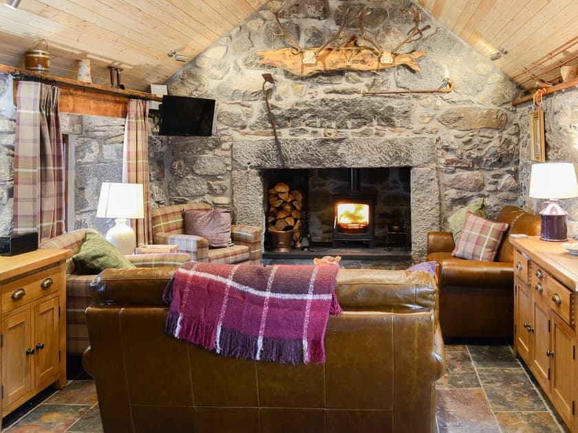 Warm and cosy open plan living space with cosy wood burner | Capercaillie Cottage, Rhilochan, Rogart, near Dornoch