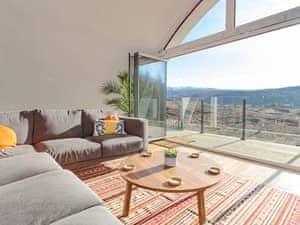 Large bi-fold doors from the living area to the balcony | Jill Strawbale House - Strawbale Collection, Strontian, near Fort William