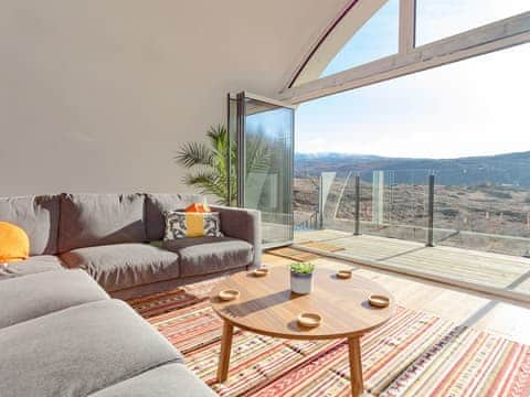 Large bi-fold doors from the living area to the balcony | Jill Strawbale House - Strawbale Collection, Strontian, near Fort William