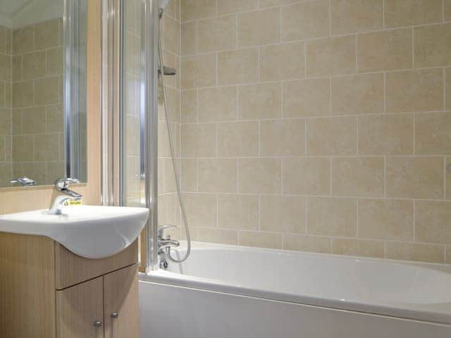 Bathroom with shower over bath | Bielby Lodge, Troutbeck Bridge, near Windermere