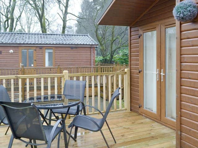 Raised decking with outdoor furniture | Bielby Lodge, Troutbeck Bridge, near Windermere