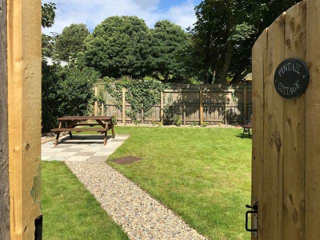 Lovely private lawned garden with small patio and picnic area | Pintail Cottage, Embleton near Craster