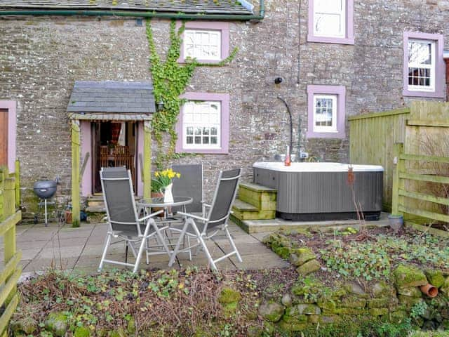 Spacious patio with hot tub and sittng out area | Woodpecker Cottage - Wallace Lane Farm Cottages, Brocklebank, near Caldbeck and Uldale