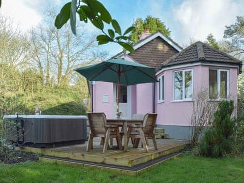 Raised decking to the rear home to the hot tub and outdoor seating | Greenacres, Reynalton, near Tenby