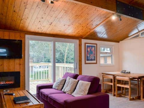 Lovely light and airy living area with patio doors to decked area | Cedar Lodge, Charlcot, near Masham