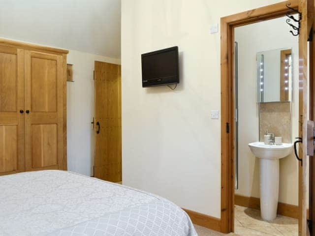 Wall mounted TV and en-suite shower room | Little Meadow - West House Farm, Dearham, near Maryport